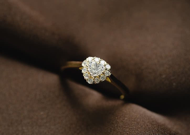 Halo engagement ring with lab-grown diamonds shaped like a flower in white gold
