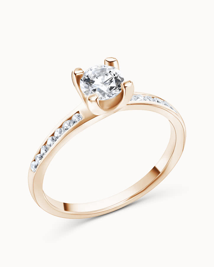 Side stone ring in 18K rose gold with a 0.5-carat center diamond from VANBRUUN