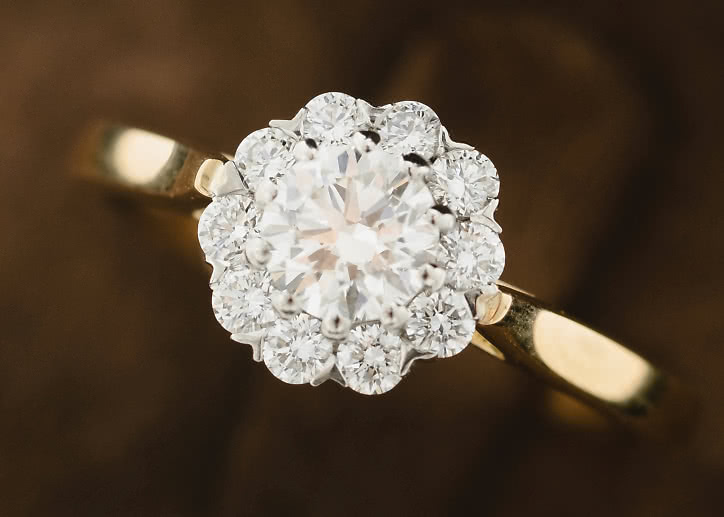 Halo engagement ring with lab-grown diamonds shaped like a flower in white gold