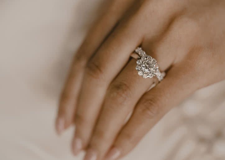 Halo engagement ring with lab-grown diamonds shaped like a flower in white gold