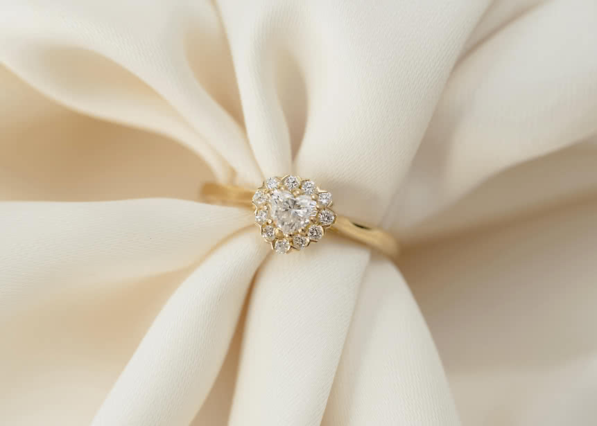 Halo engagement ring with lab-grown diamonds shaped like a flower in gold