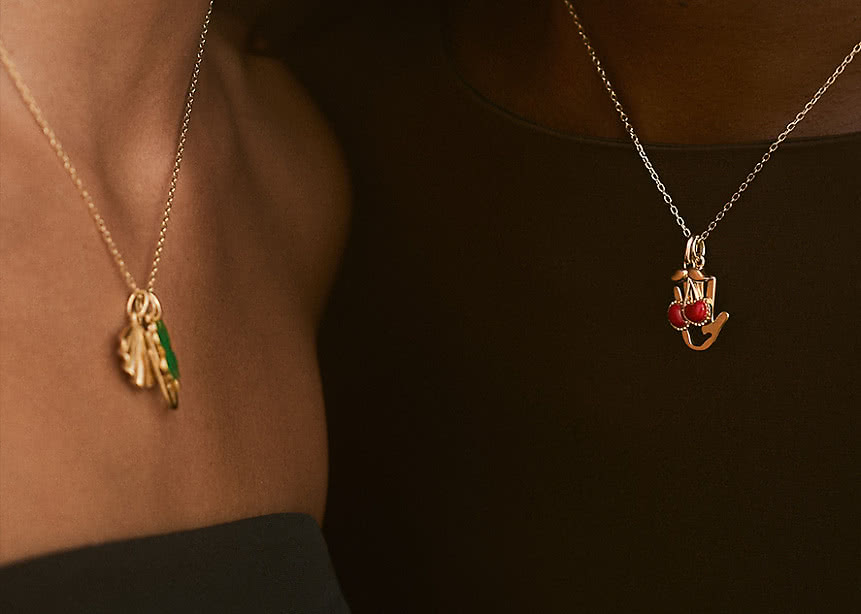 Two women wearing necklaces in 18K Yellow Gold from the VANBRUUN x CHILDHOOD collection.